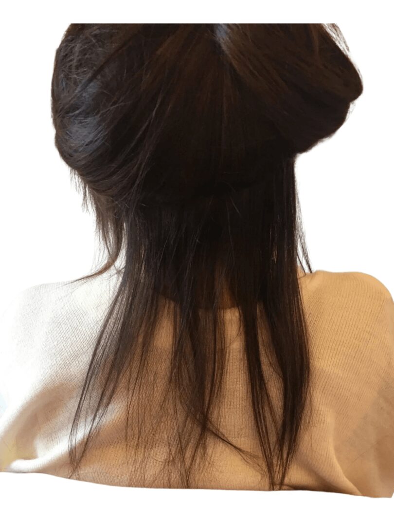 closeup shot of the tied black hair of a woman